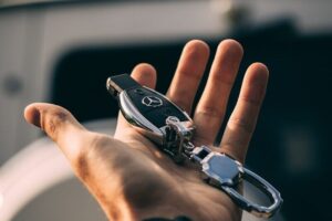 person holding Mercedes-Benz fob